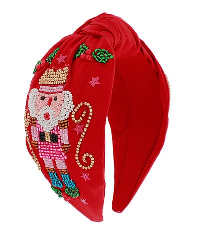 Red Christmas headband with hand-beaded Nutcracker soldier design, sequins, pearls, and seed beads.