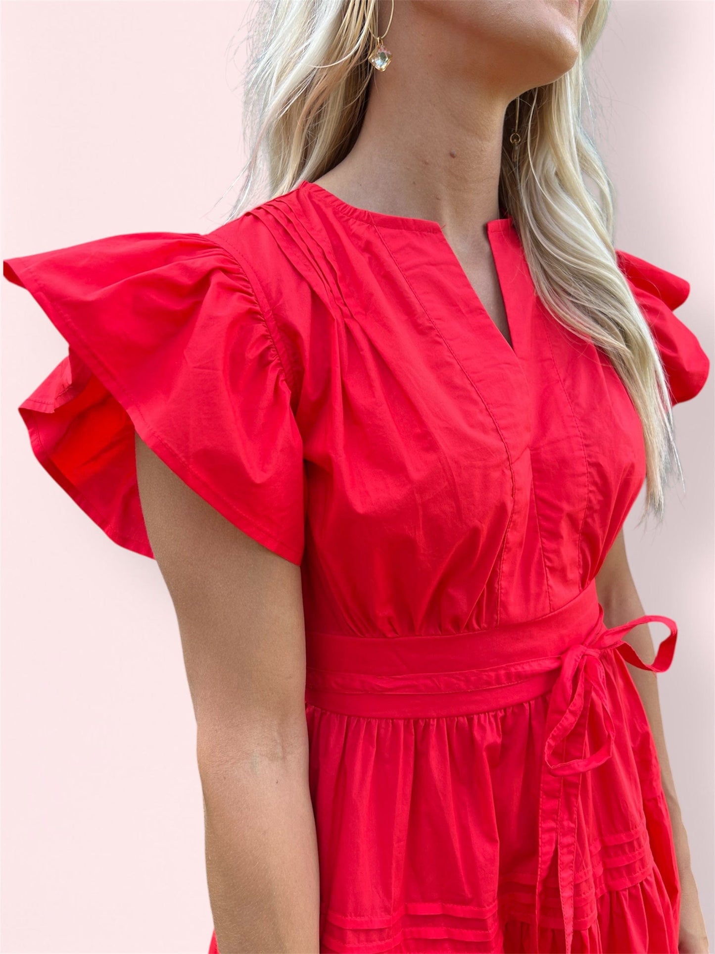 Close-up of the Cala Midi Dress detailing the neckline and ruffled sleeve