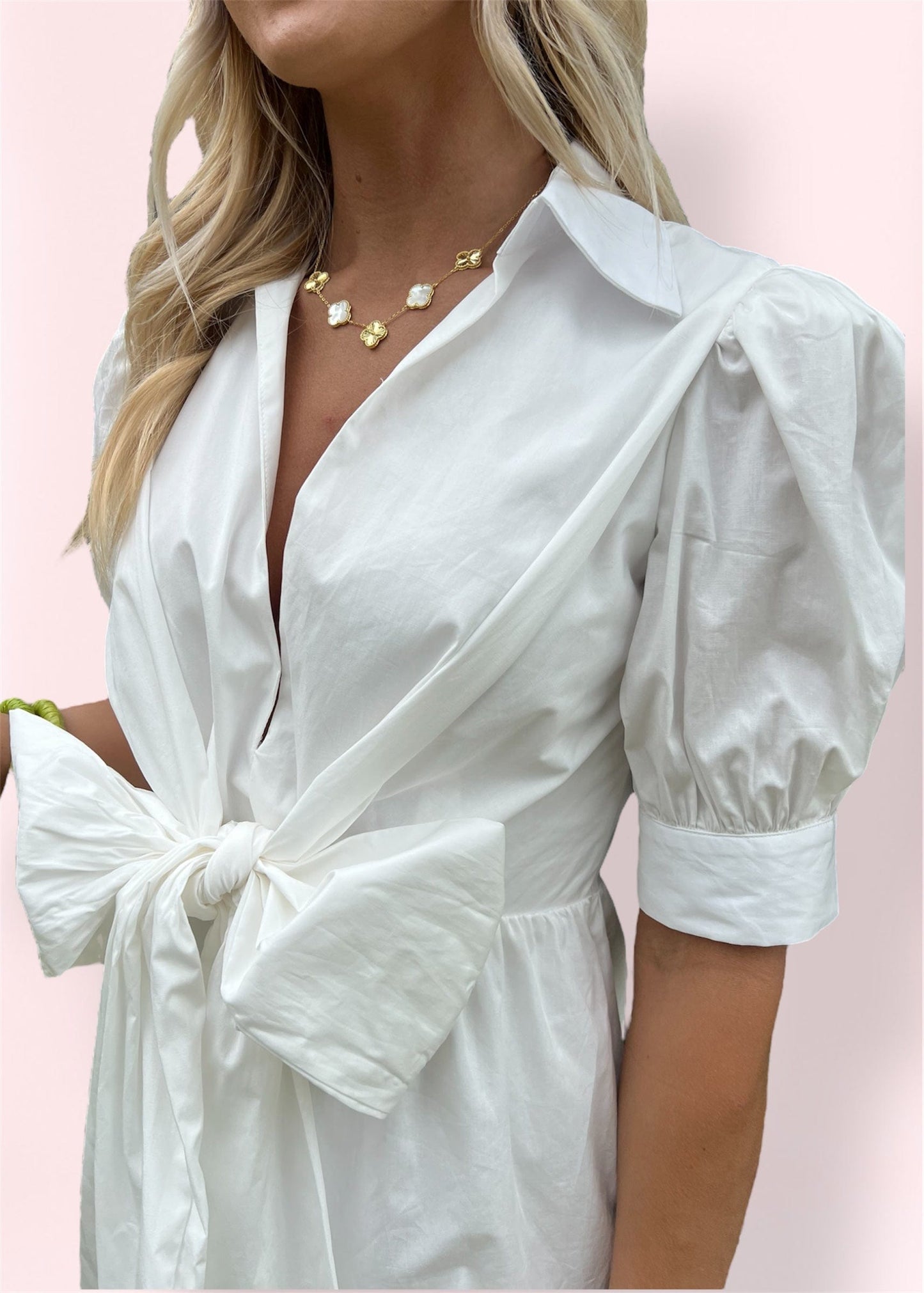 Close-up of the Lolita Bow Dress highlighting the oversized front bow, puff sleeves with cuffed ends, and the crisp collared neckline with subtle sheen.