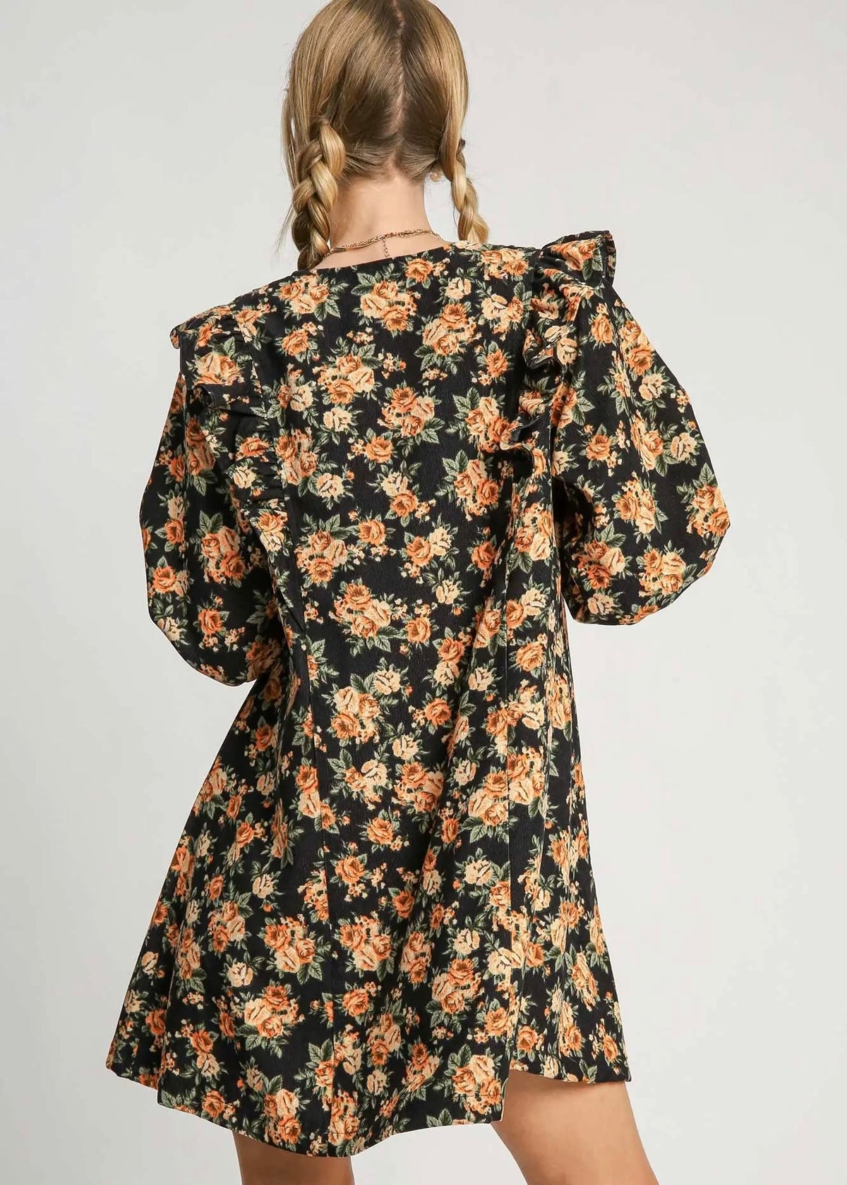 Back view of black and rust floral mini dress with relaxed silhouette