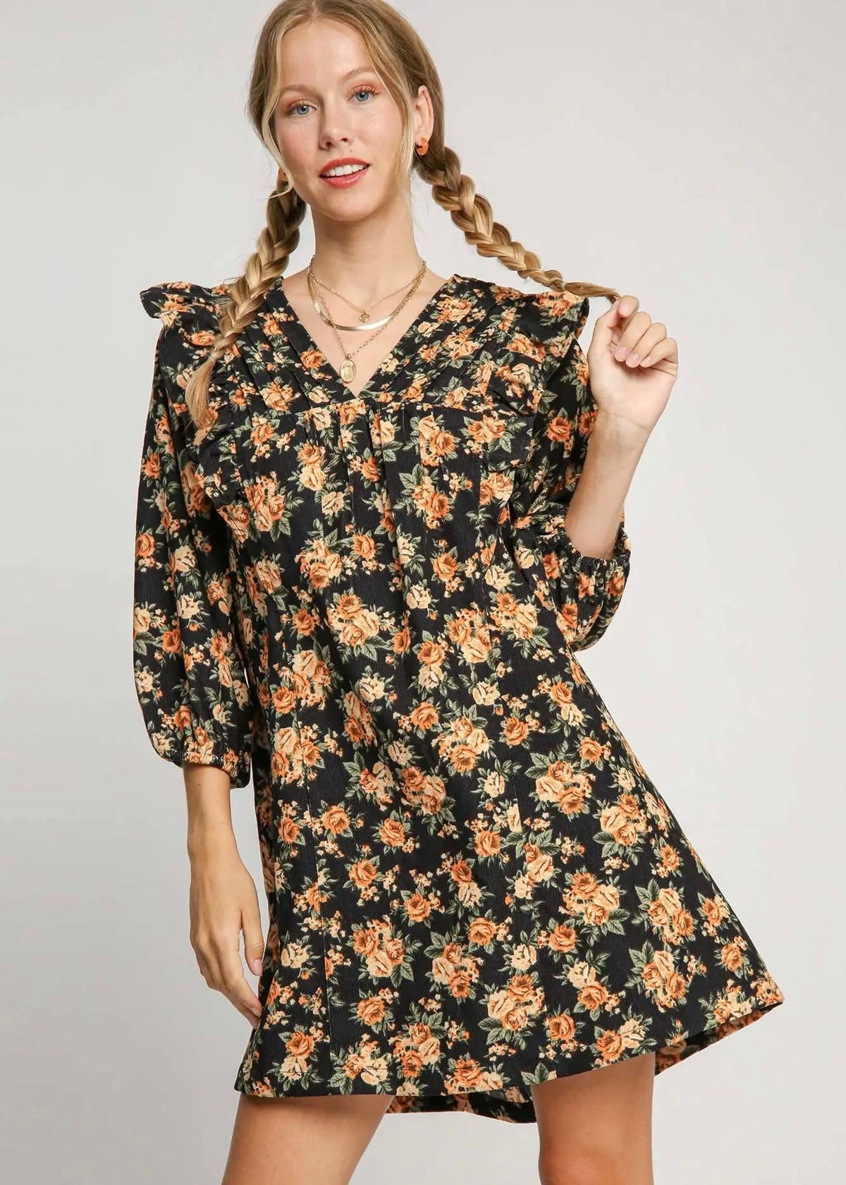 Black floral mini dress with orange flowers, V-neckline and ruffle shoulders