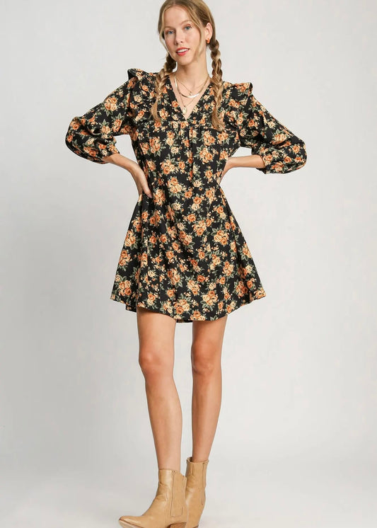 Women's black fall floral mini dress styled with tan ankle boots