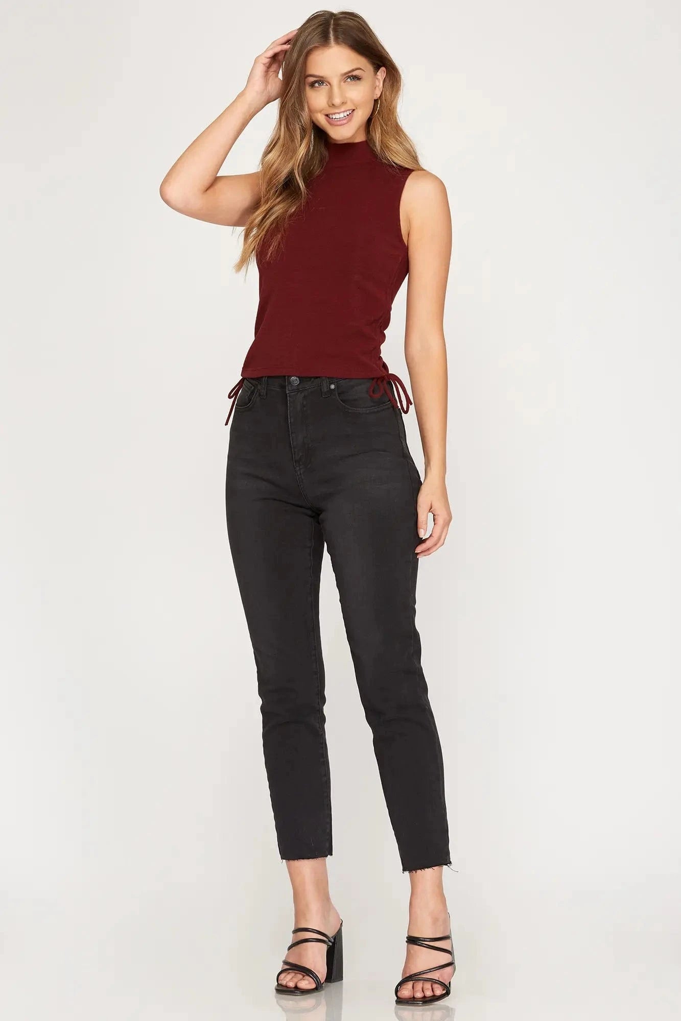 Model posing in chestnut crop top with mock neckline