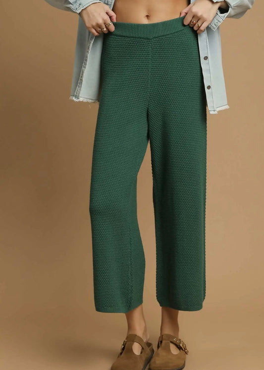 Front view of forest green cropped wide leg knit pants with ribbed waistband