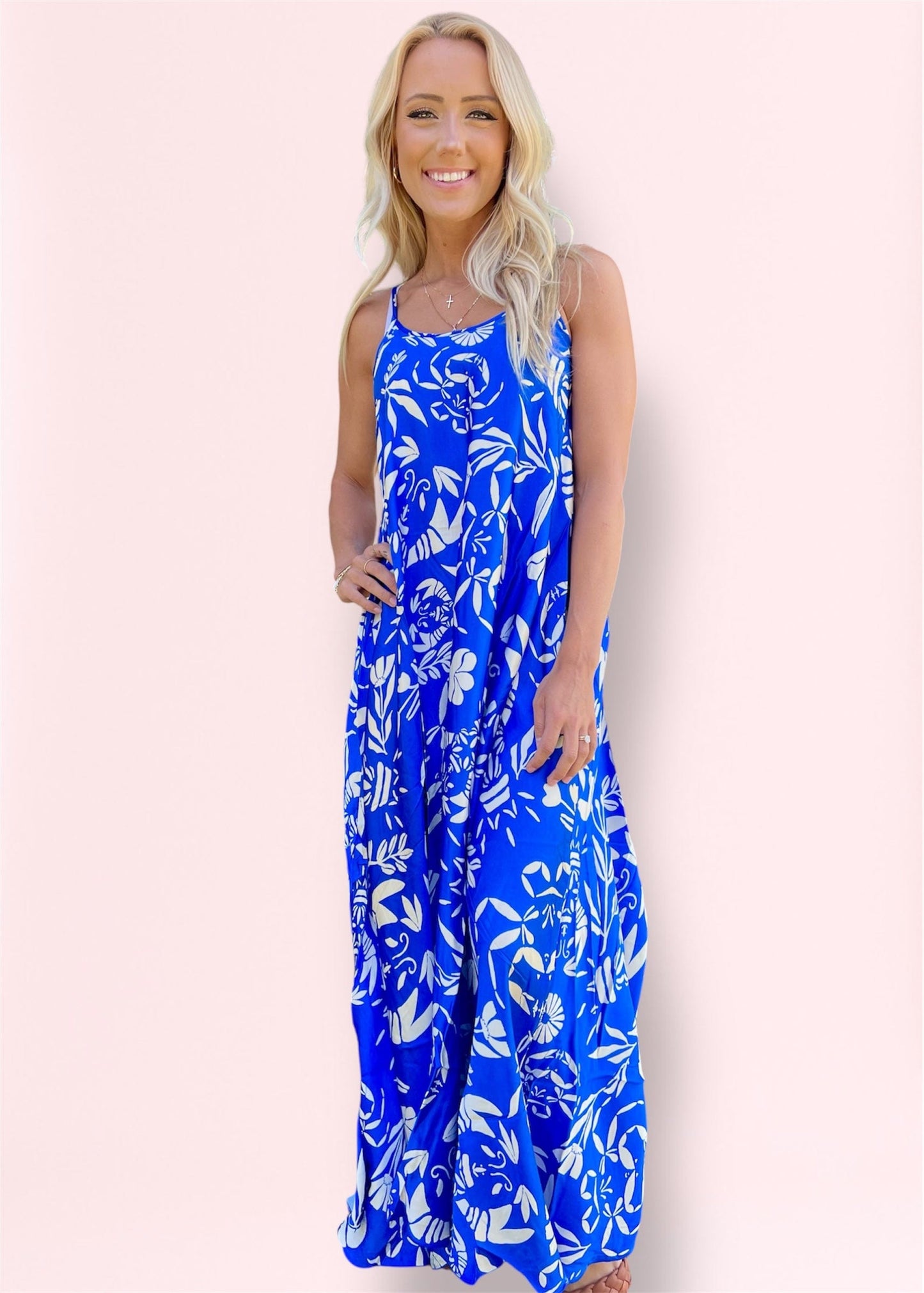 Front view of the Isys Maxi Dress in soft white, featuring a flowy silhouette and adjustable spaghetti straps, made in Italy for luxury comfort.