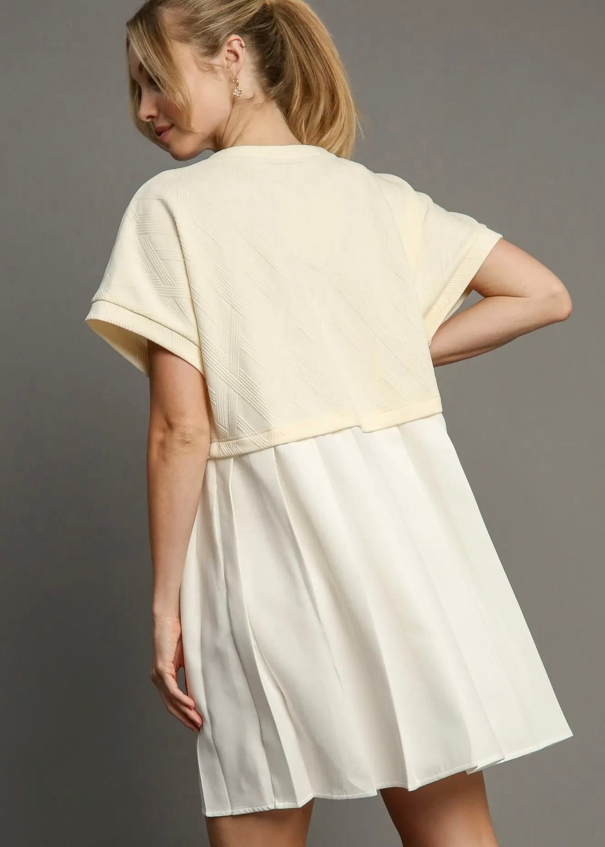 Back view of ivory short sleeve textured mini dress