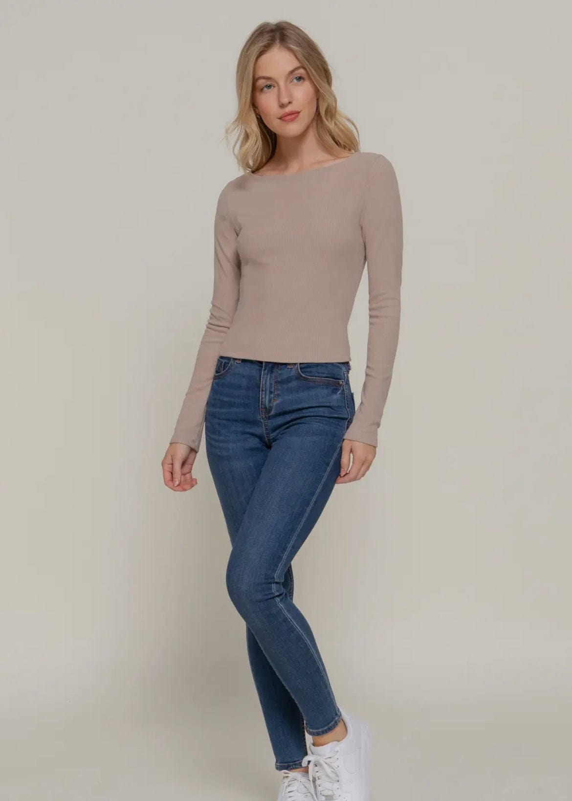 Mocha cropped top layered under vest for transitional styling