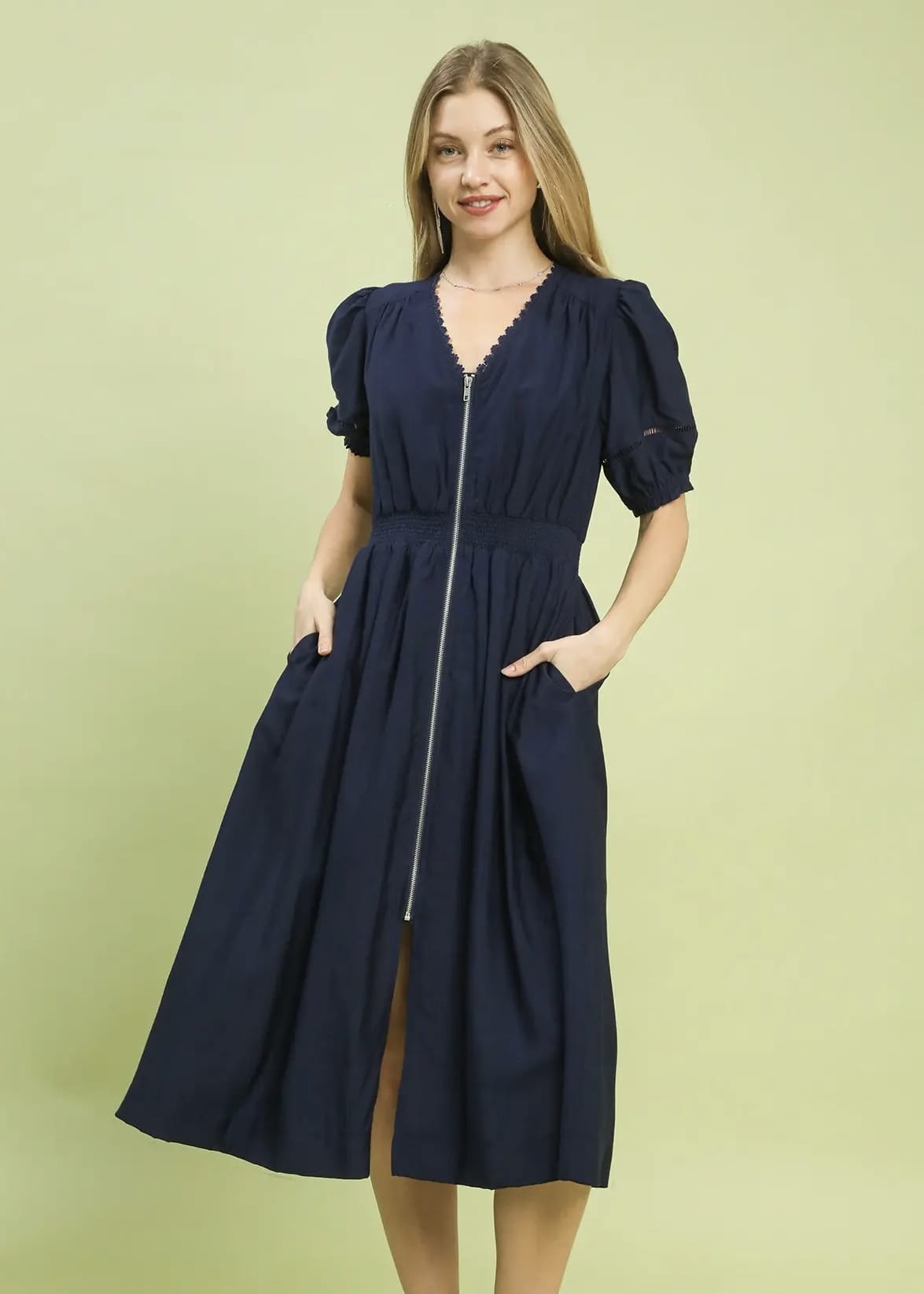 Navy blue midi dress with puff sleeves, smocked waist, and front zipper