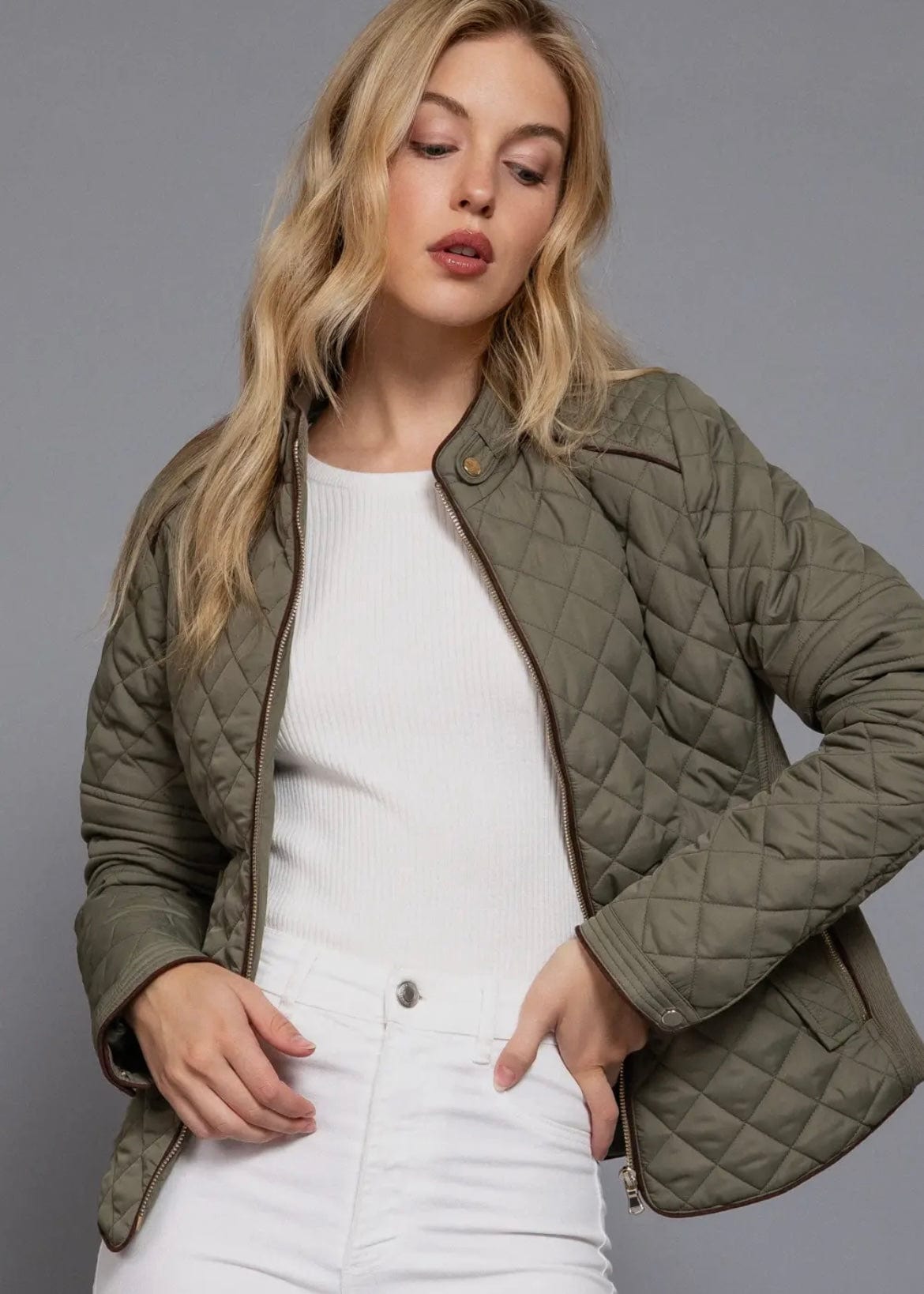 Olive green quilted jacket worn open over white top – casual fall outfit idea