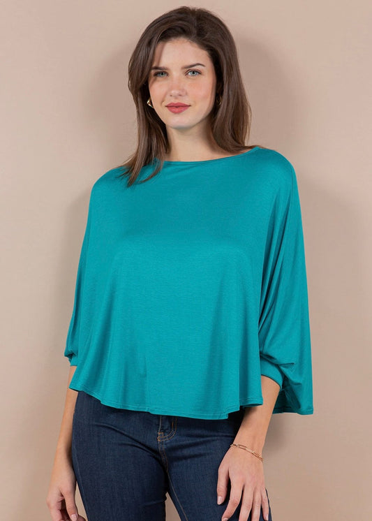 Woman wearing turquoise one-size cape top with batwing sleeves