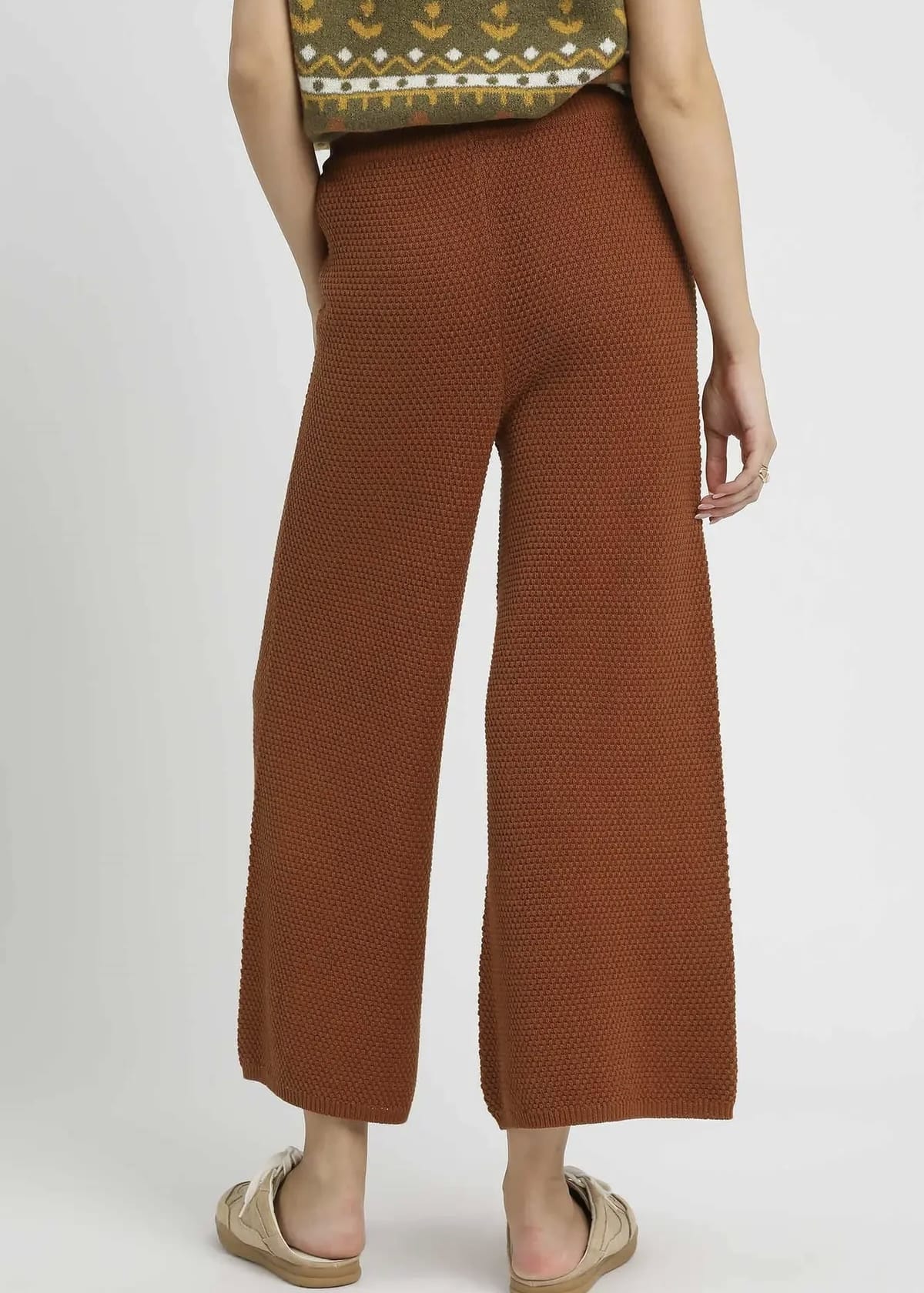 Back view of rust brown wide leg textured knit pants