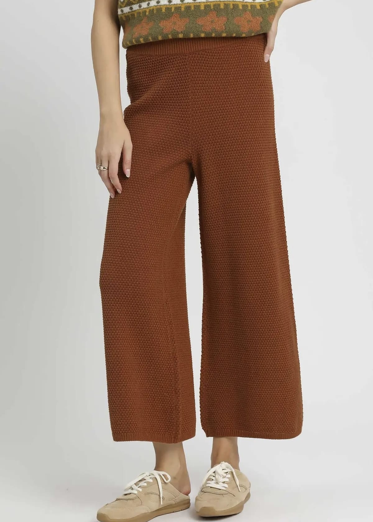 Front view of rust brown textured knit wide leg pants