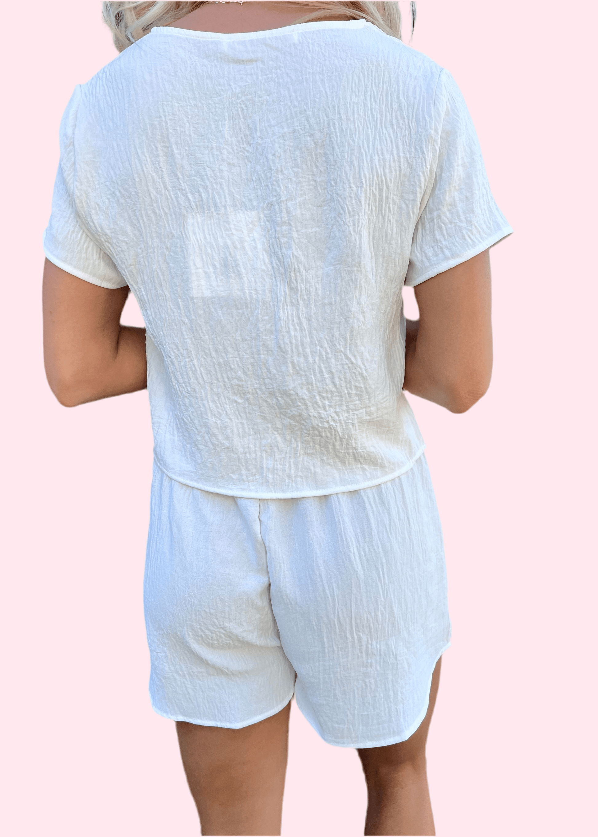 Back view of women's white shorts set with minimalist silhouette and comfortable design
