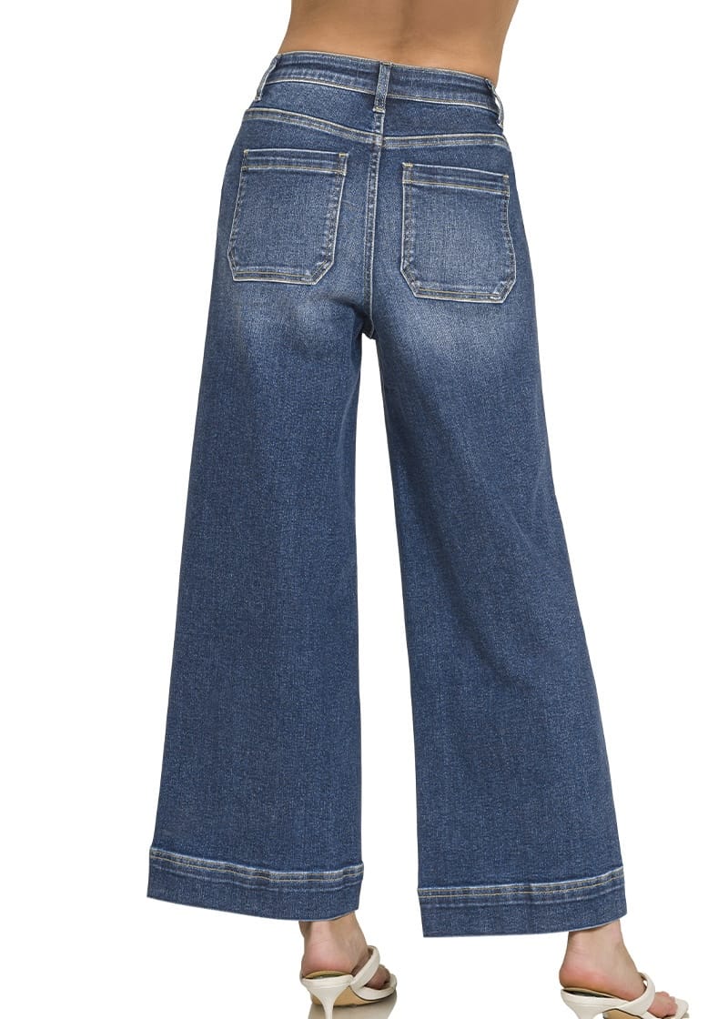 Back view of women’s dark wash high rise wide leg jeans with pockets